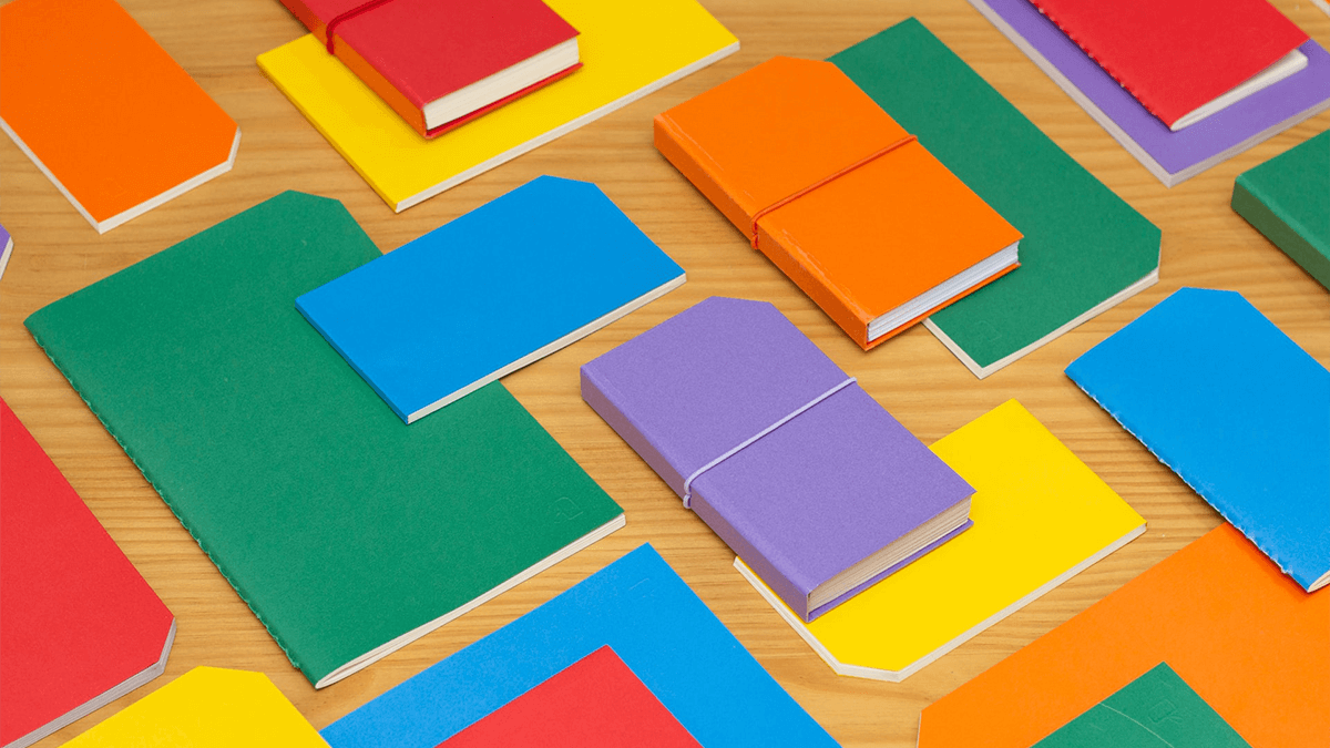 Colorful image of folders and notebooks on a desk