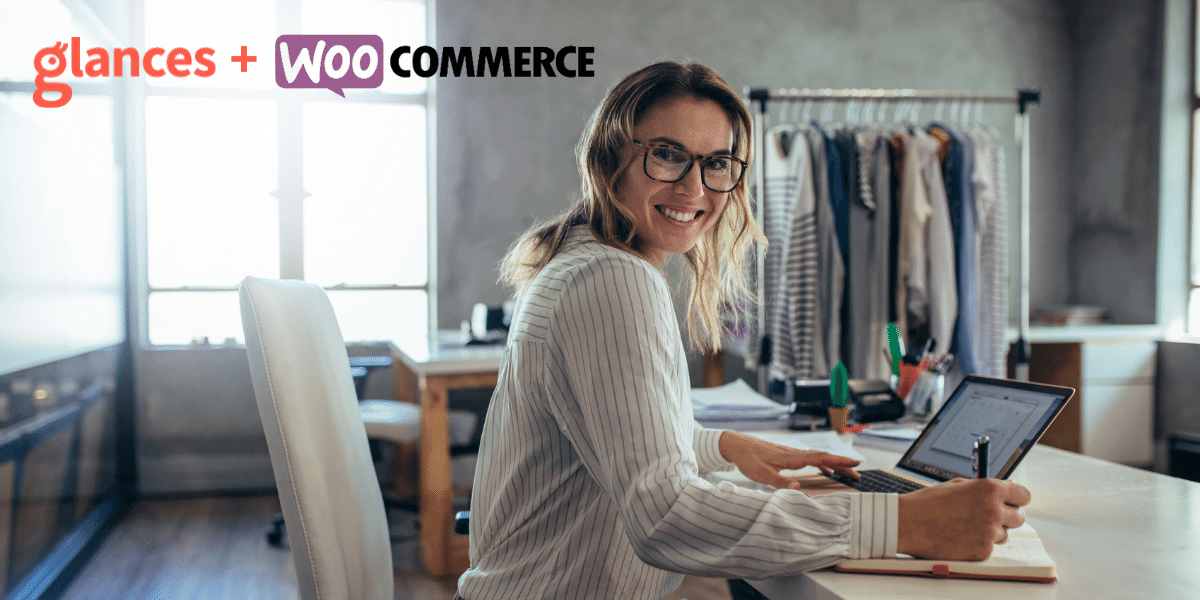 Connect WooCommerce to all your apps with Glances Lady at work on a desk smiling with a rack of clothes in the background